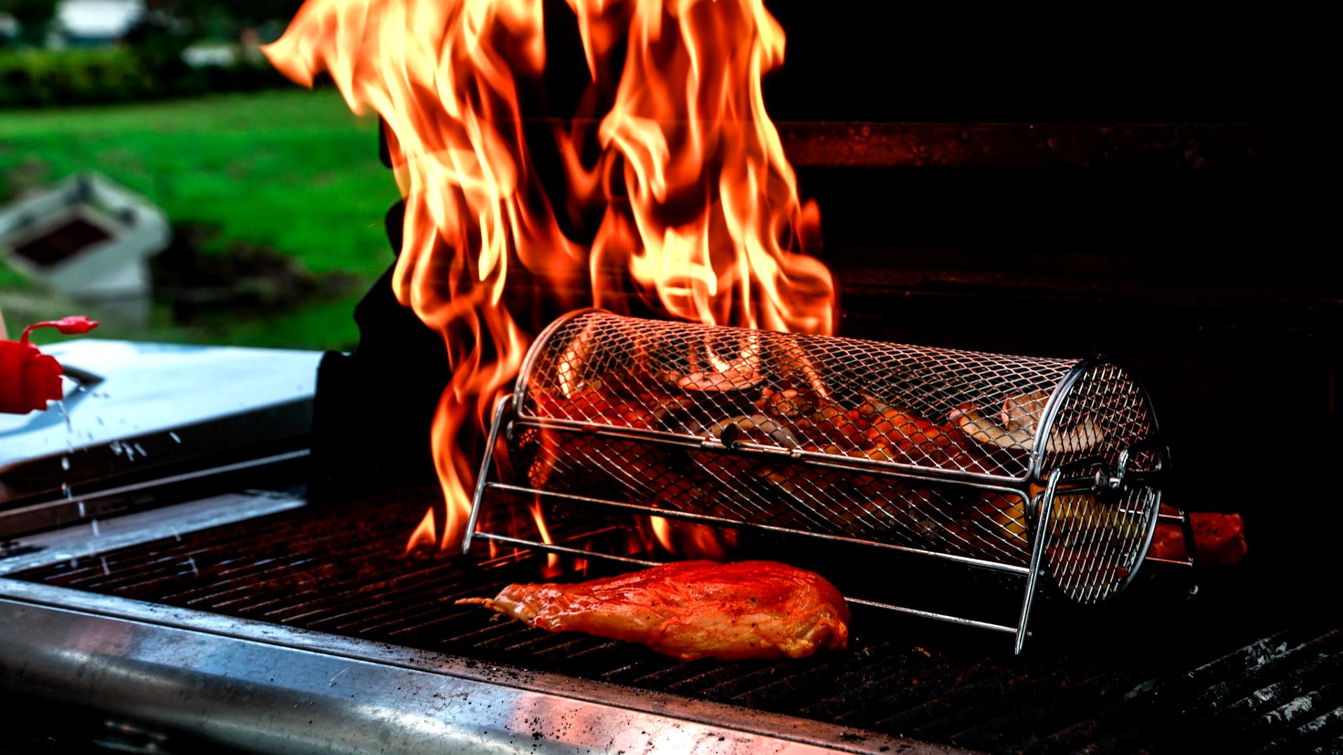 High flames rising while cooking on the BBQ grill.