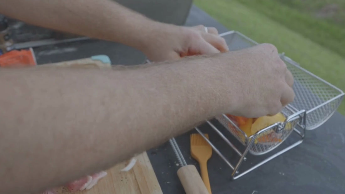 Grilling skewers using Smokr’s BBQ basket outdoors with Smokr tools nearby.